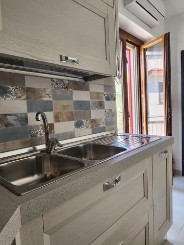 a kitchen with a sink and a counter top at Il Pizzuto - Appartamento da Nonna Anna in Bernalda