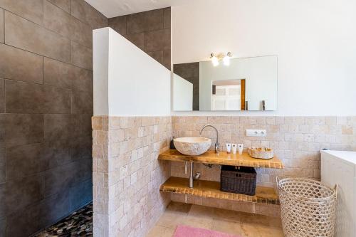 a bathroom with a sink and a mirror at Sunset Villa Cala Tarida & Cala Comte & Cala Bassa in Port des Torrent