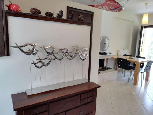 a kitchen with a large window with antlers on the wall at Rhea Panorama sea view house in Kókkinon Nerón