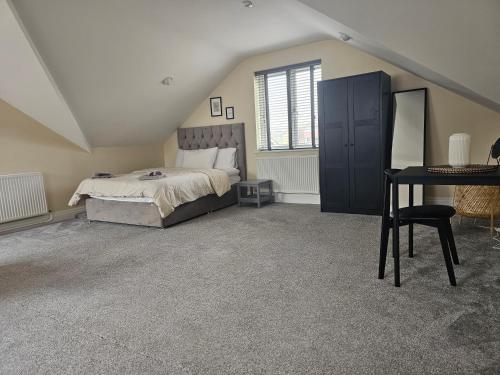 a bedroom with a bed and a desk in it at 1 Bed Loft - Sleeps 2 - Parking - Wifi in Newport