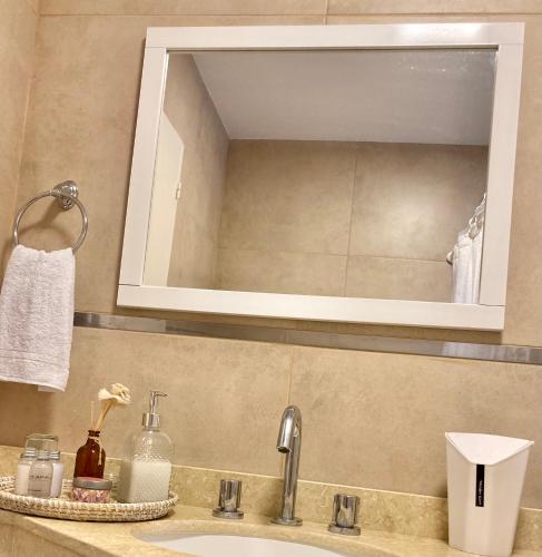 a bathroom sink with a mirror above it and a sink at Yerba Buena Lofts - Monoambiente con Cochera in Yerba Buena