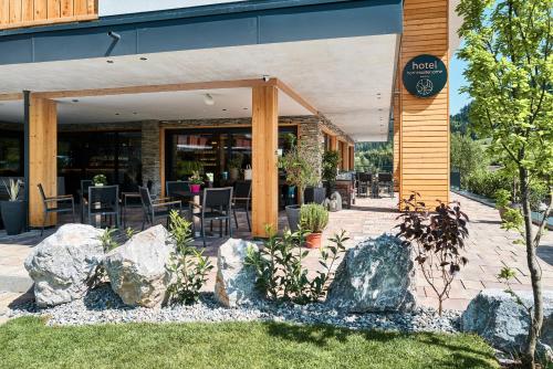 a restaurant with rocks in front of a building at Home suite home in Fieberbrunn
