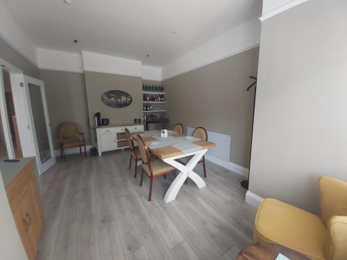 a dining room with a table and chairs at Bay House in Totland