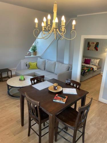 a living room with a table and a couch at Apartamet Gabriel in Tykocin