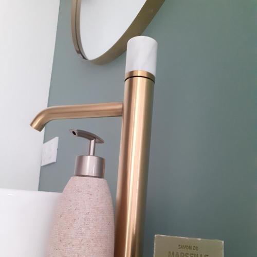 a close up of a lamp and a soap dispenser at L escapade in Saint-Siffret