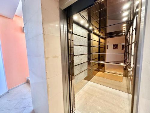 a hallway with a glass door in a building at Menada Miramar Palace Apartments in Sunny Beach