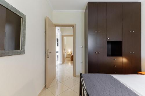 a bedroom with a bed and wooden cabinets at Villa Fabiola in Vergia