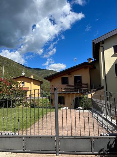 a fence in front of a house at Casa Conchet in Polcenigo