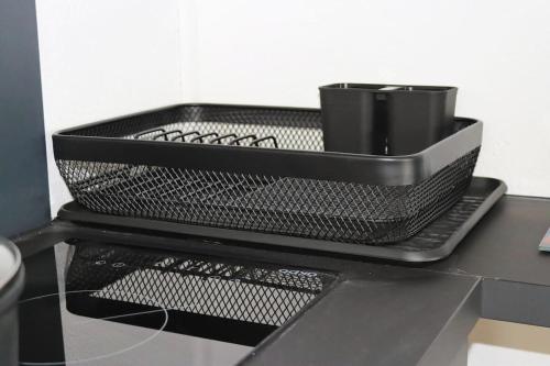 a black basket sitting on top of a counter at la lapia in Monthey