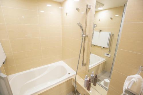 a bathroom with a shower and a tub and a sink at NEW OPEN City View Suite in Minami-Azabu in Tokyo