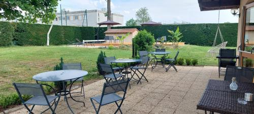a group of tables and chairs sitting on a patio at Etesia in Feurs