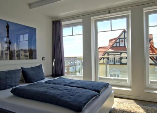 ヴァンガーオーゲにあるWoogeQueen - 112 m² Luxus mit direktem Meerblickのベッドルーム1室(ベッド1台、大きな窓付)