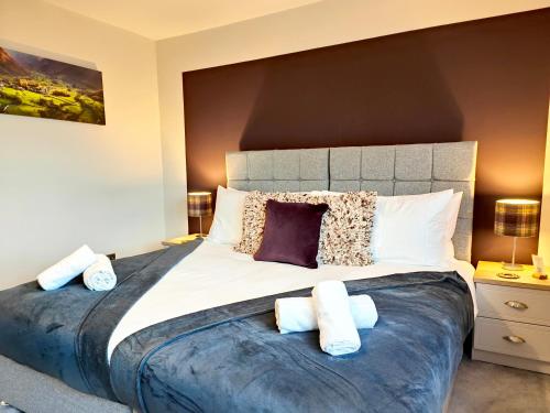 a bedroom with a large bed with pillows on it at Yewtree House in Penrith