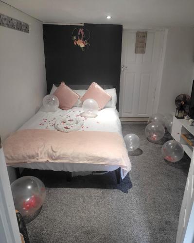 a bedroom with a bed with lots of latex spheres around it at Hidden Treasure-Netflix and Wi-Fi in Gillingham