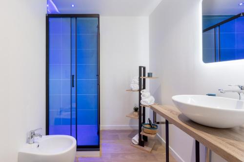 uma casa de banho com 2 lavatórios e uma cabina de duche em vidro. em Daddi rooms & apartment em Cagliari