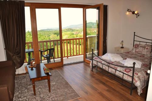 a bedroom with a bed and a balcony with a view at Agriturismo Gradec in Aurisina