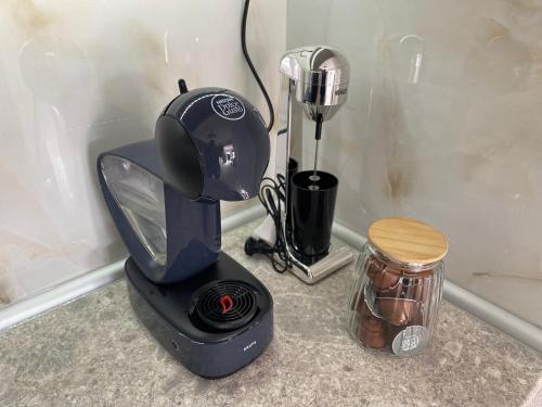 a black blender sitting on a counter with a jar at Momo's House in Nikiti