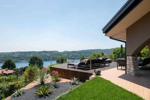 a house with a patio with a view of the water at Villa Allegra Luxury Holiday House in Salò
