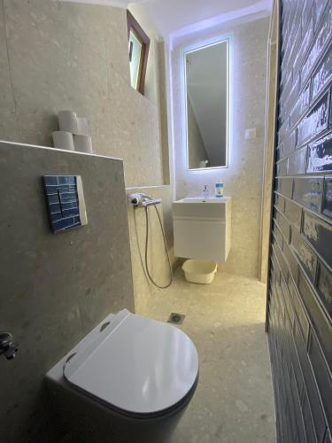 a bathroom with a toilet and a sink at Momo's House in Nikiti