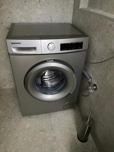 a washing machine in the corner of a room at Momo's House in Nikiti