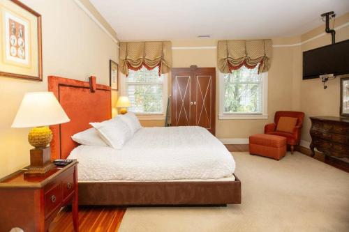 a bedroom with a large bed and a chair at Relaxed Studio close to Duke & Downtown Durham in Durham