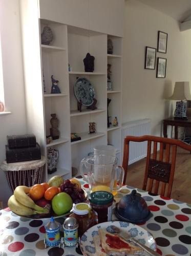 a table with a plate of fruit and a drink at Westwaterhead in Kingsbridge