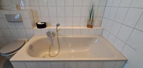 a white bathroom with a tub and a toilet at 4ty-Veitsrodt in Veitsrodt