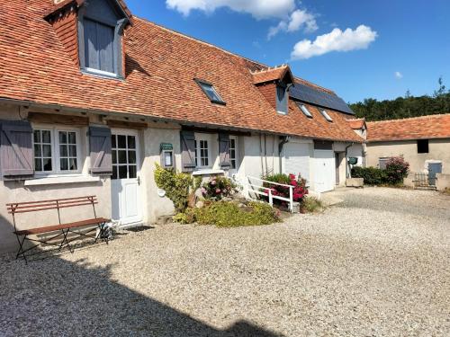 a house with a bench in front of it at la ferme des bigornes in Châtillon-sur-Indre