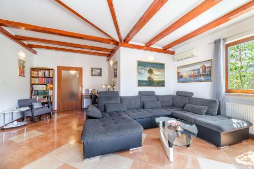 a living room with a couch and a table at Guest house Barbara in Nerežišća