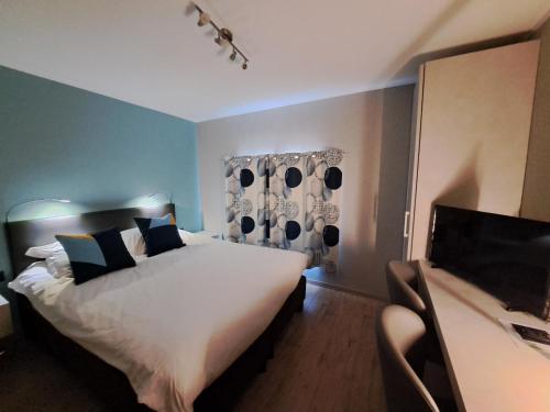 a bedroom with a large white bed in a room at Chanteloup, Maison d'hotes - Halleux in Halleux