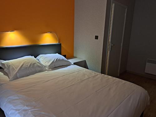 a bedroom with a white bed with two pillows at Chanteloup, Maison d'hotes - Halleux in Halleux