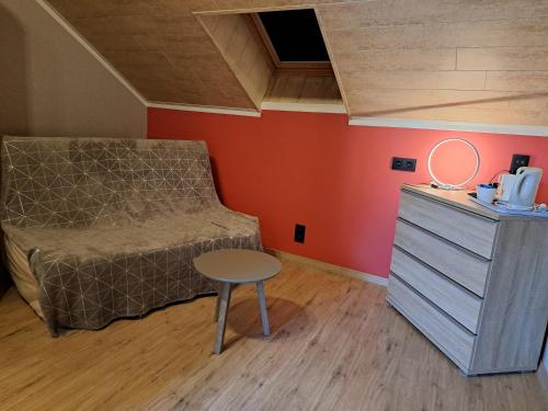 a bedroom with a bed and a table and a dresser at Chanteloup, Maison d'hotes - Halleux in Halleux