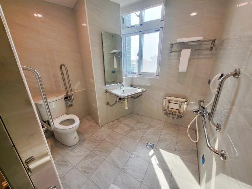 a bathroom with a toilet and a sink at Gucheng International Hotel 