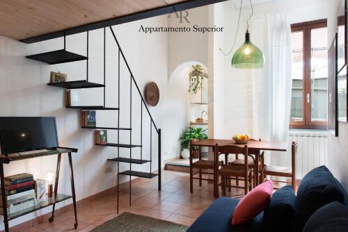 a living room with a spiral staircase and a table at Appartamenti Ridolfi in Empoli