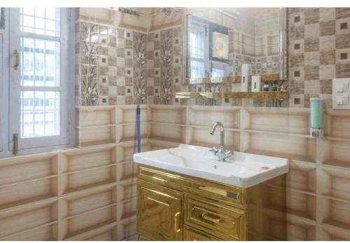 a bathroom with a sink and a mirror at Riva dreams in Dharamshala