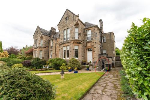 an old house with a garden in front of it at The Lindsay House in Stirling