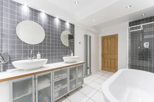 a bathroom with two sinks and a shower at The Lindsay House in Stirling