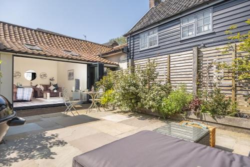 a backyard of a house with a patio at The Clockhouse in North Lopham