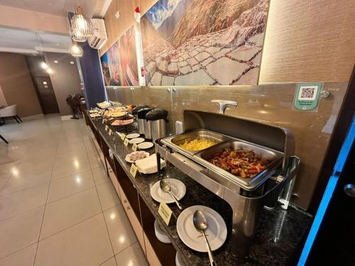 a buffet line in a restaurant with food on it at Hotel El Tambo 2 in Lima