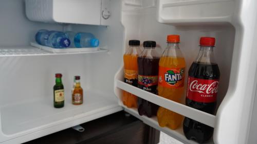 a refrigerator filled with bottles of cocacola at Думан Холл Отель in Taraz