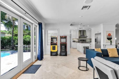 a living room with a blue couch and a kitchen at Luxury 3 Bedroom Home 5 minutes to Ocean with Heated Pool in Hollywood