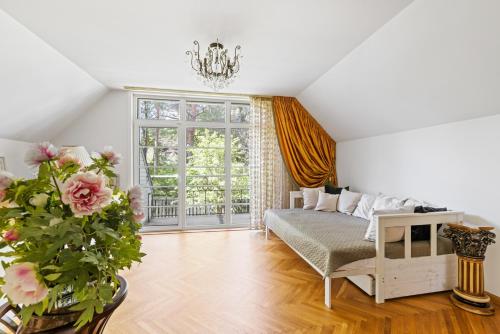 a living room with a bed and a window at Villa Muusa in Tallinn