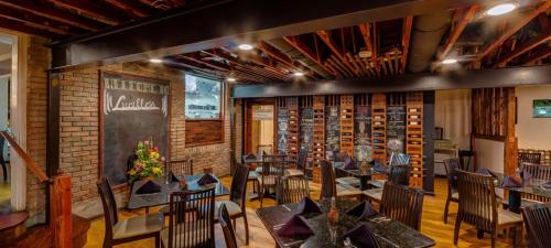 a restaurant with tables and chairs and a brick wall at StarryNight at Museum Park - WORLD CUP in Houston