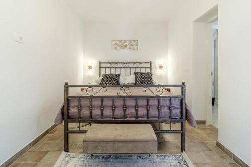 a bed in a white room with a sqor sqor at Josipa in Supetar