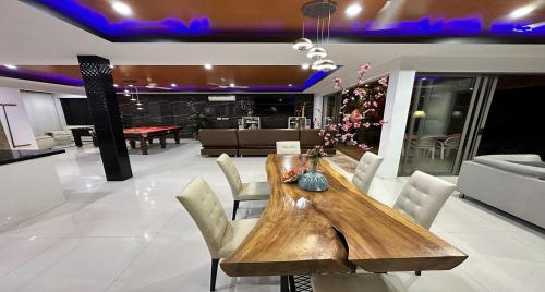 a dining room with a wooden table and chairs at Villa Jacuzzi Seaview Villa in Chaweng Noi Beach