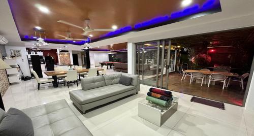 a living room with a couch and a dining room at Villa Jacuzzi Seaview Villa in Chaweng Noi Beach