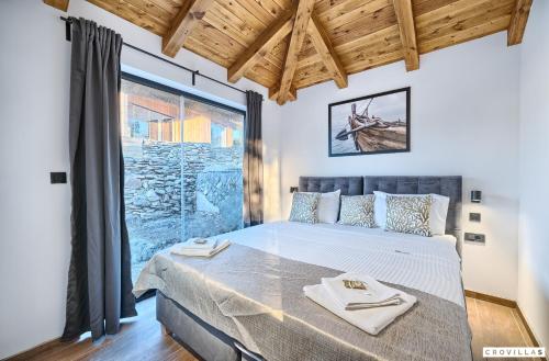 a bedroom with a large bed and a large window at Lux Ii in Murter