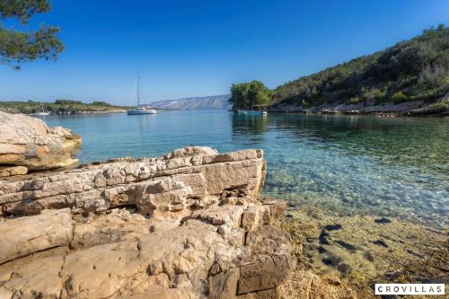 a view of a river with a boat in the water at Nella Hvar in Rudina
