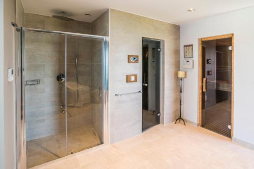 a shower with a glass door in a bathroom at Monte in Momjan