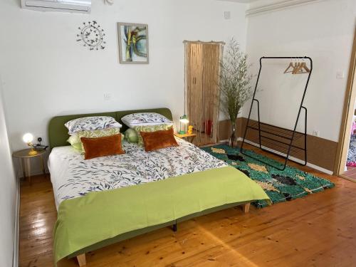 a bedroom with a bed with pillows and a rug at Tonzzini in Krbune